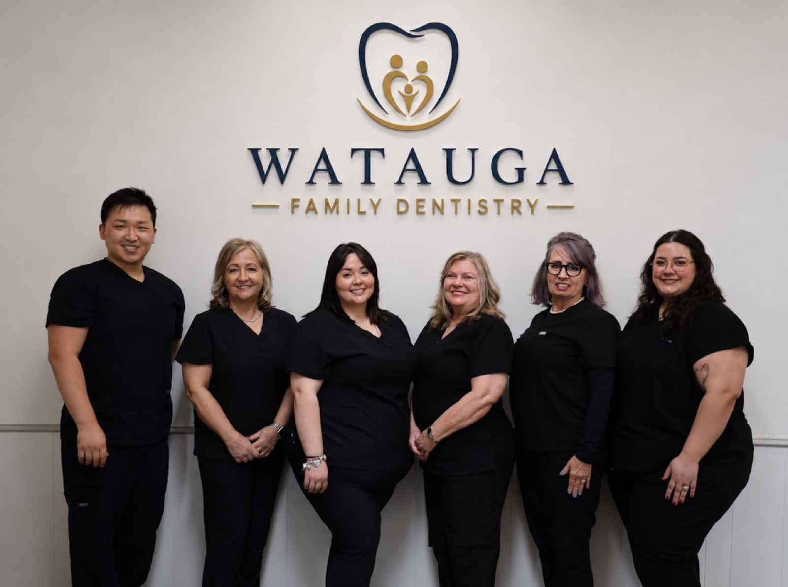 The Watauga Family Dentistry team in front of our logo